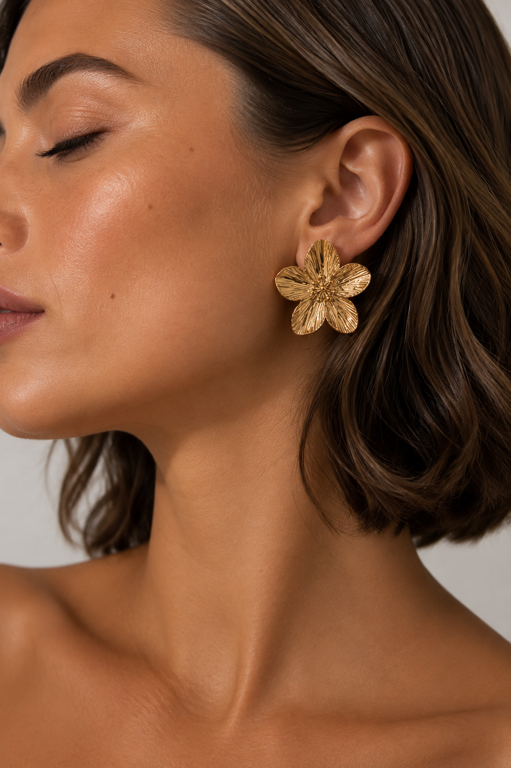 Bloom Gold Studs worn in ear close up