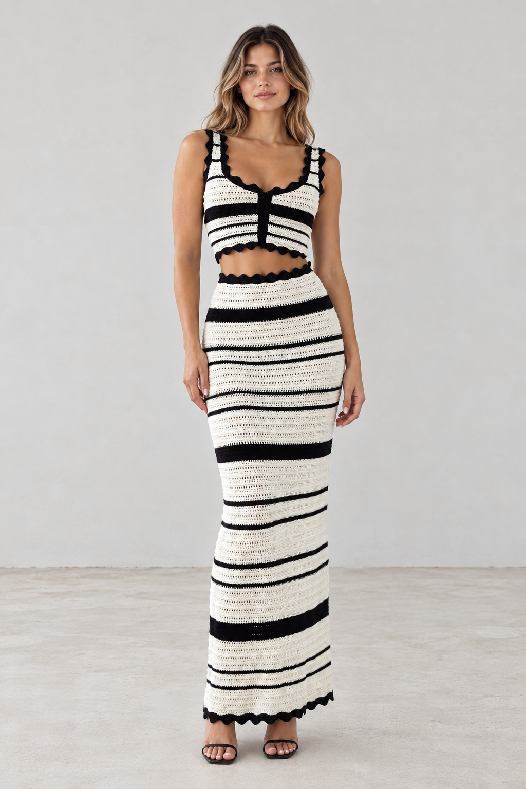 Front view of black and ivory striped crochet crop top and maxi skirt set
