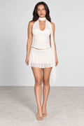 Straight-on front view of ivory halter corset mini skirt set with neutral expression