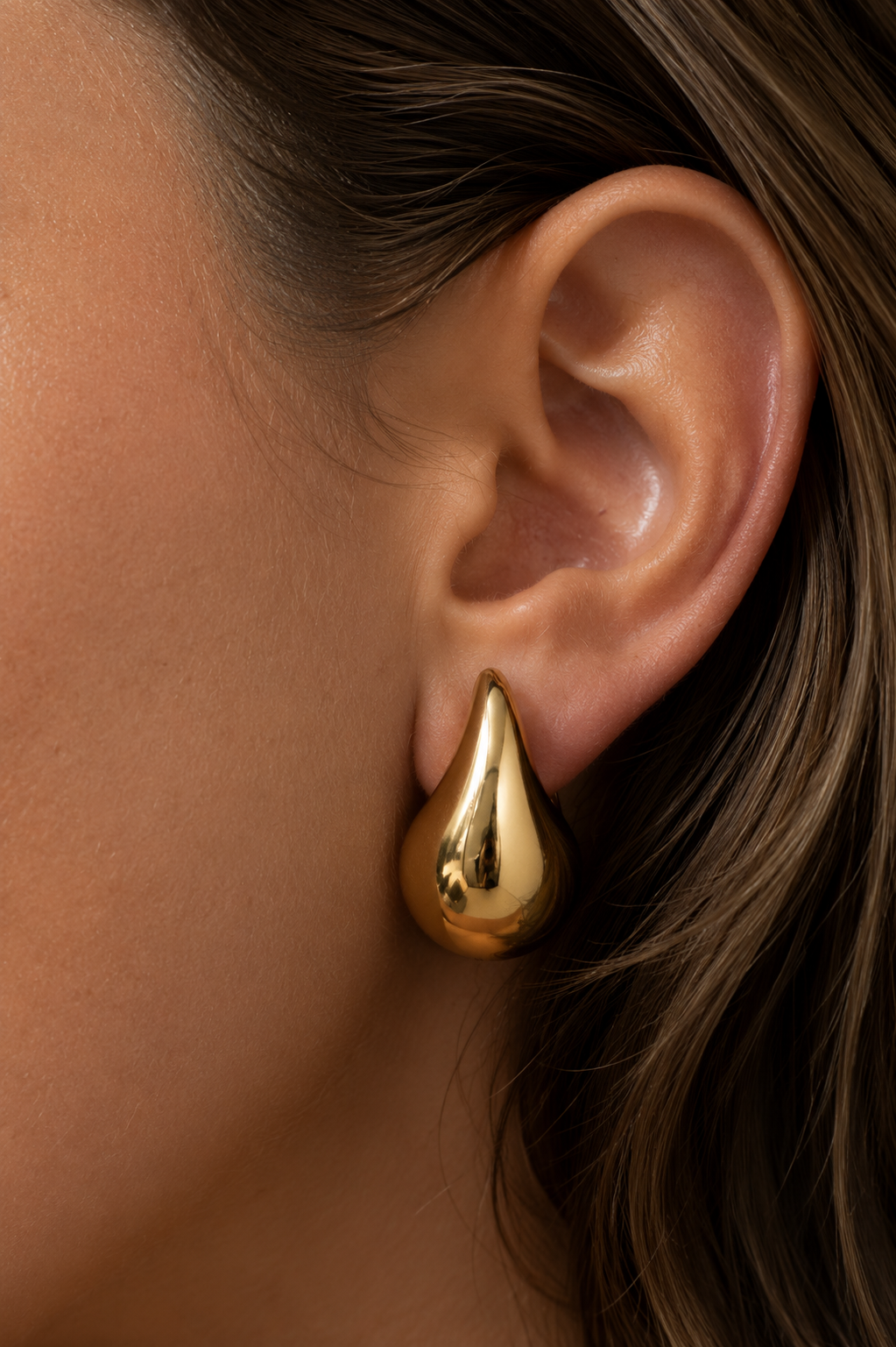 Nova Gold Drop Earrings worn in ear close up